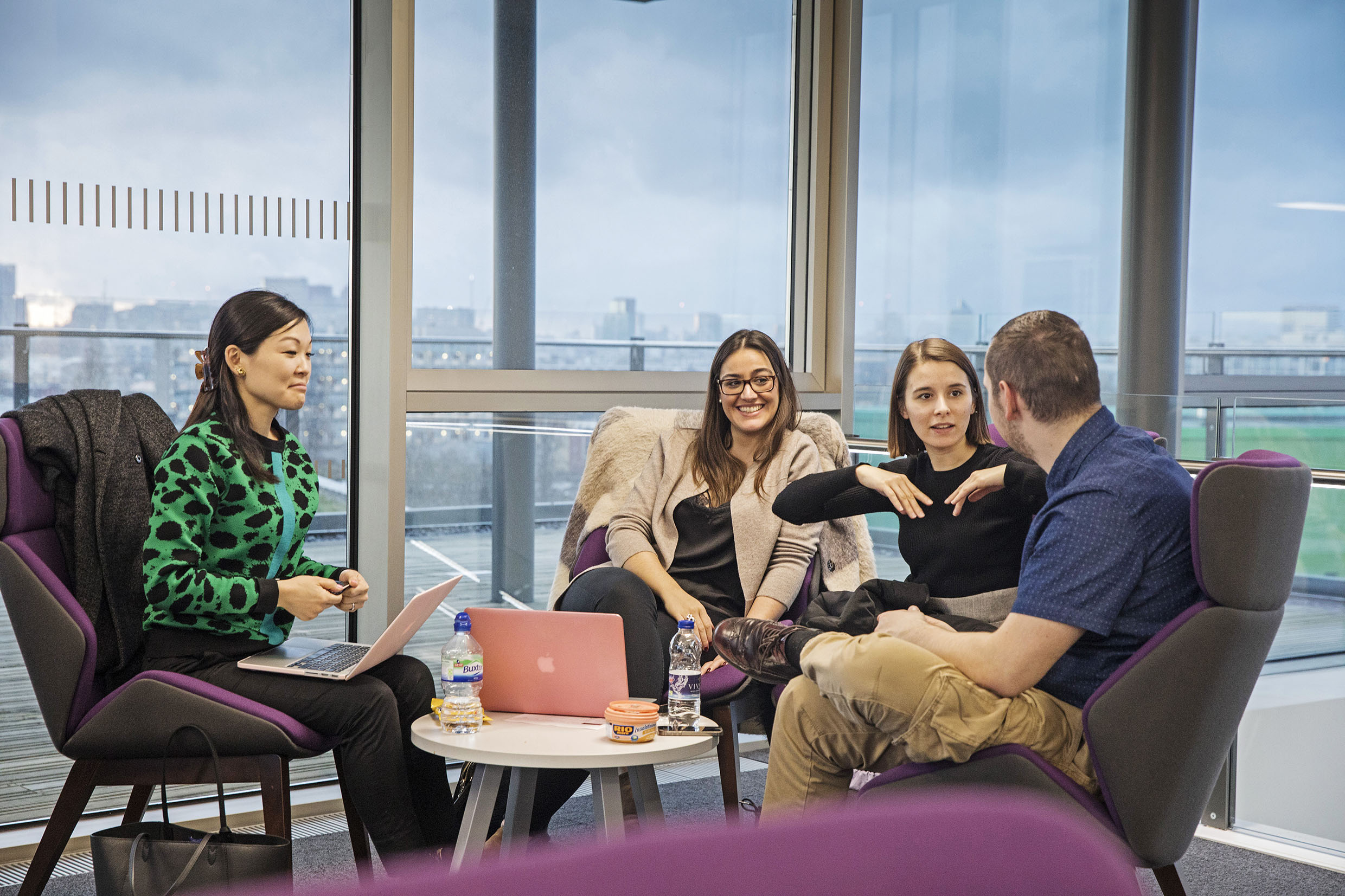 A group of postgraduate research students in conversation