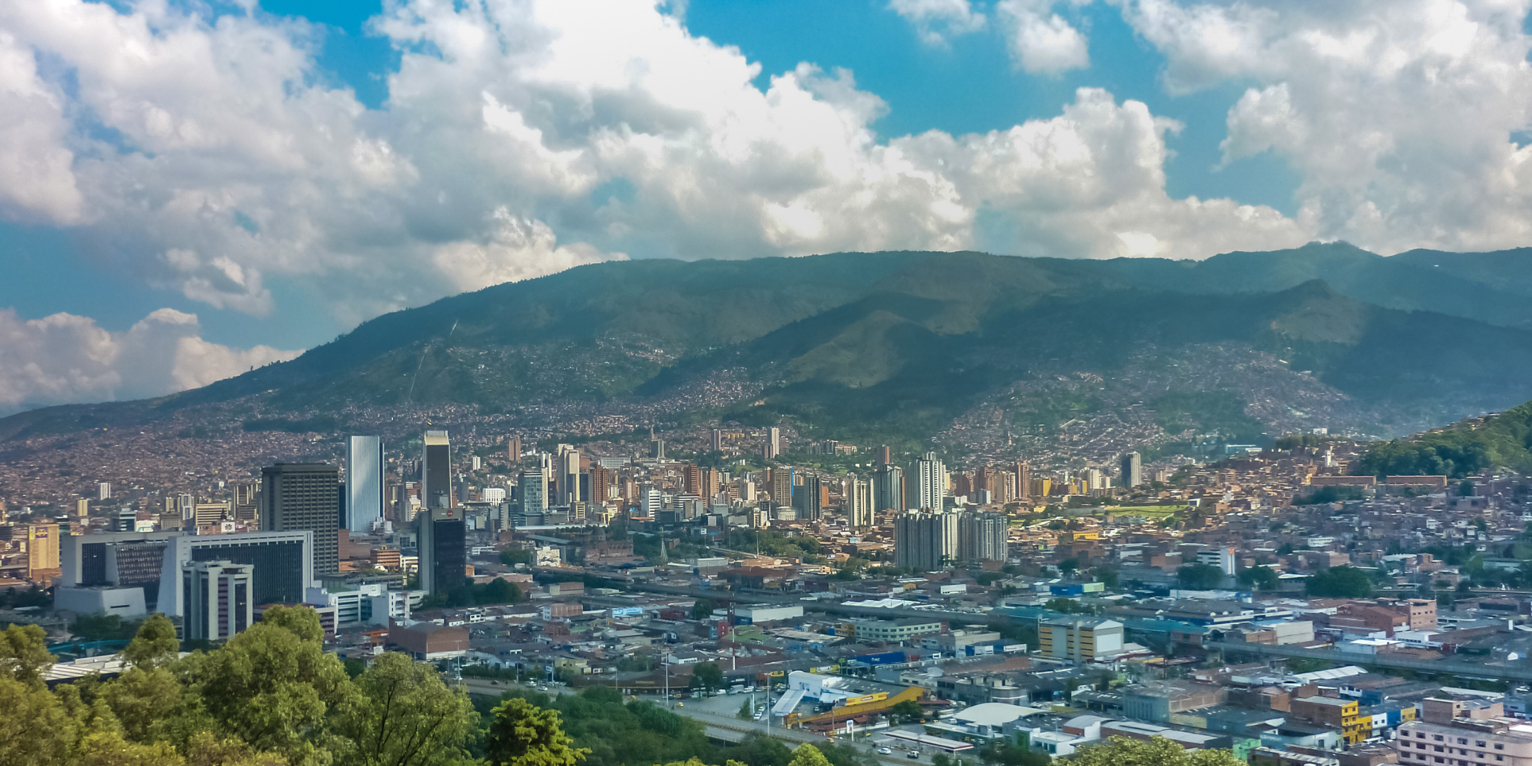 City, clouds and mountains