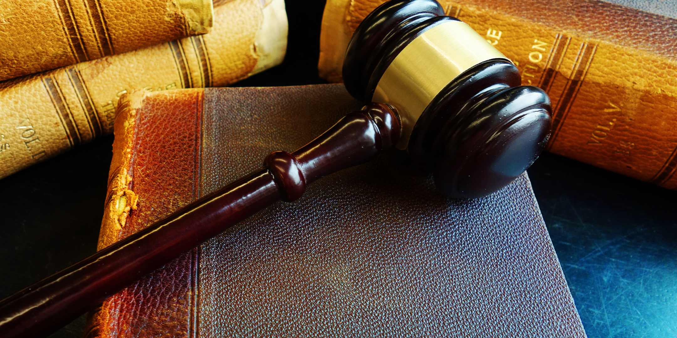 A brown gavel on top of a book