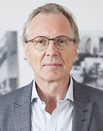 Christoph Menk. He's wearing a suit jacket and shirt and glasses.