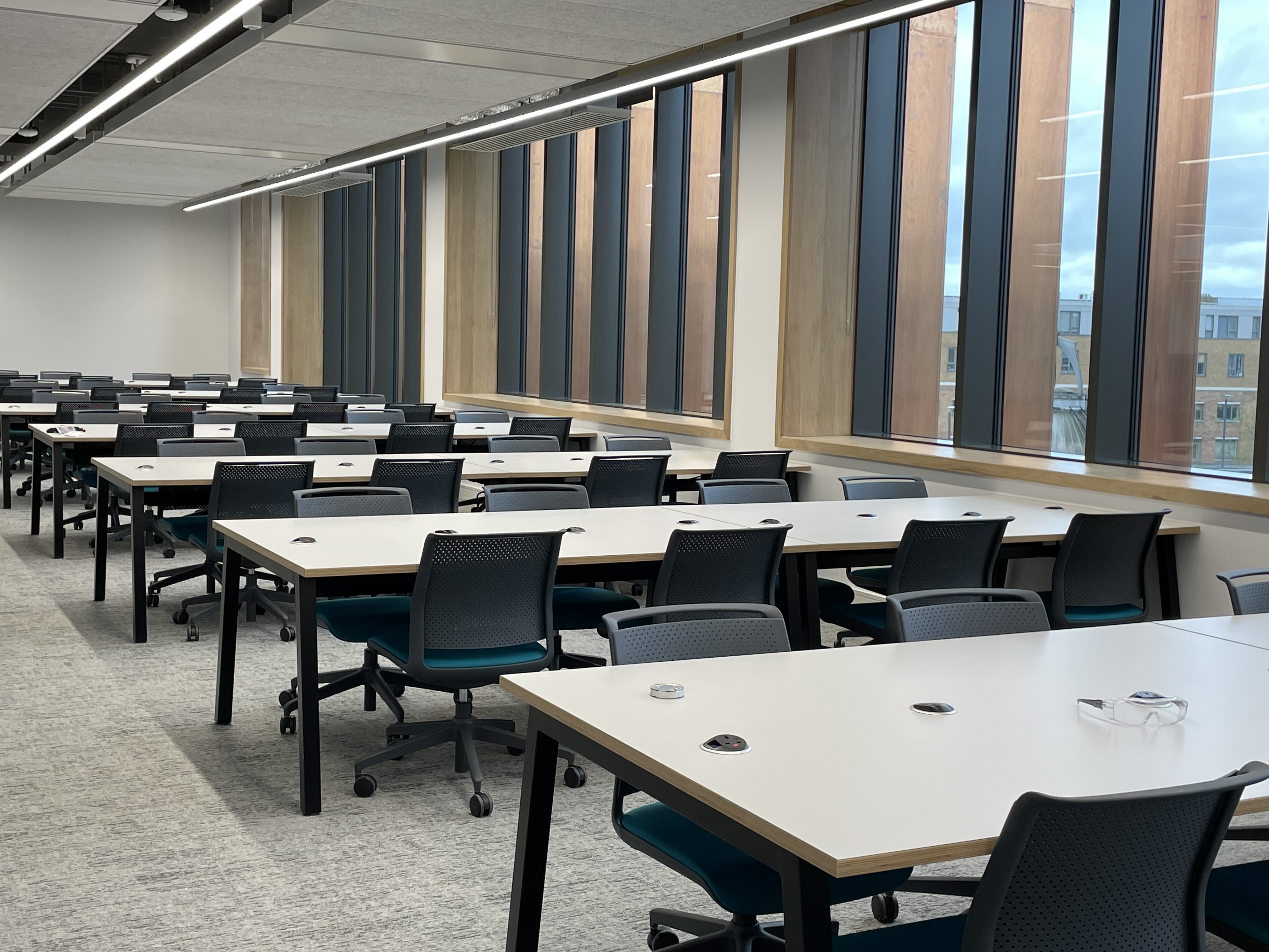white desks grey carpet windows