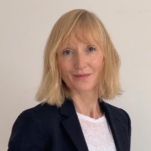 Headshot of Louise Ashley wearing a black suit jacket and white top
