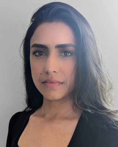 A photo of Shreyaa standing in front of a white background